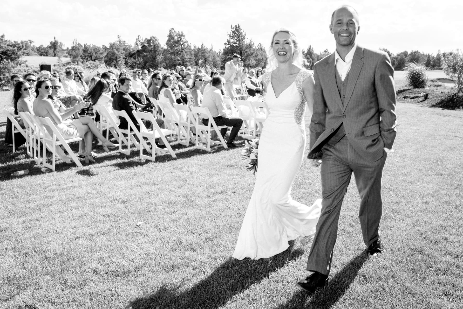 Newlywed couple walking down the aisle after their ceremony